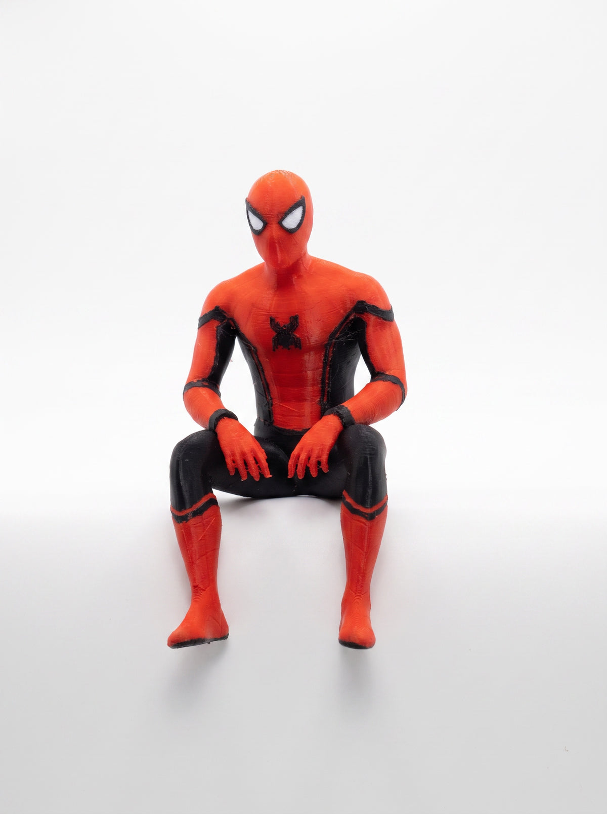 Spider shelf sitter figure, seated front view on a white background